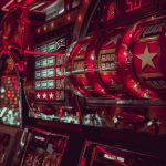 Close-up of a vintage slot machine with bright red graphics and lights
